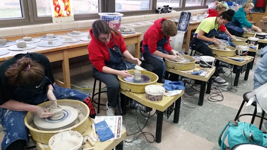 Picture of students working on a pottery wheel